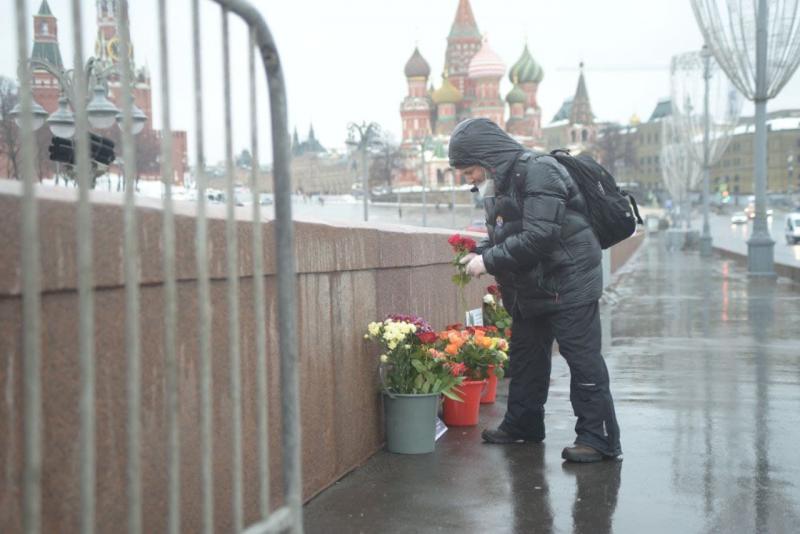Люди несут цветы к мемориалу Немцова