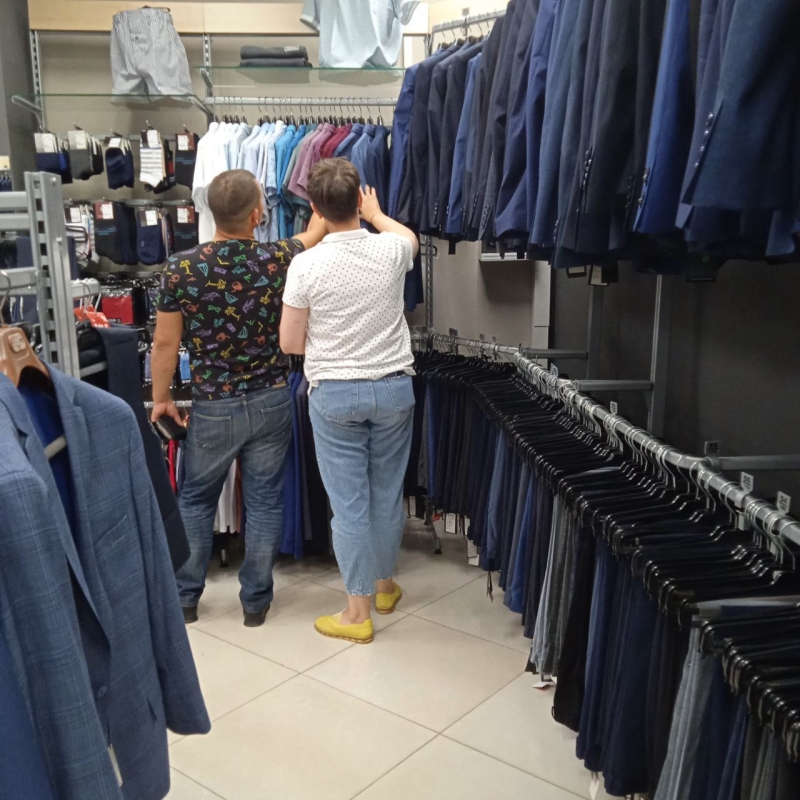 Мужчины выбирают одежду в магазине