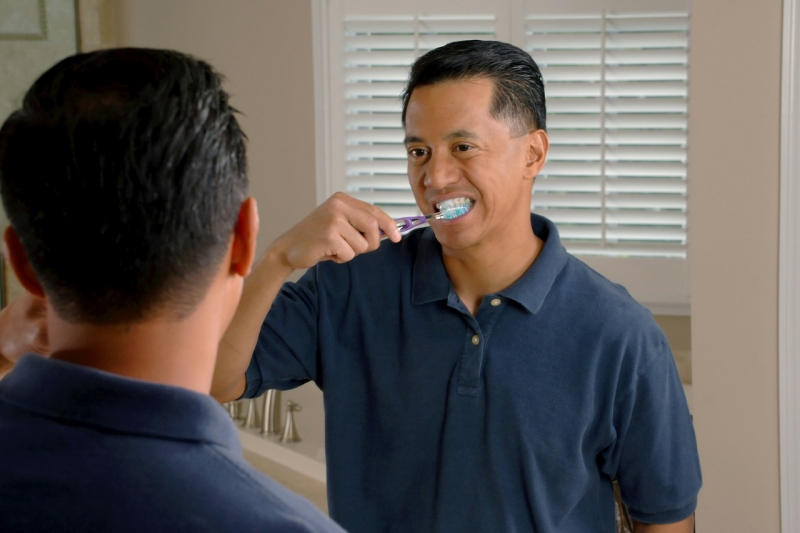 мужчина чистит зубы