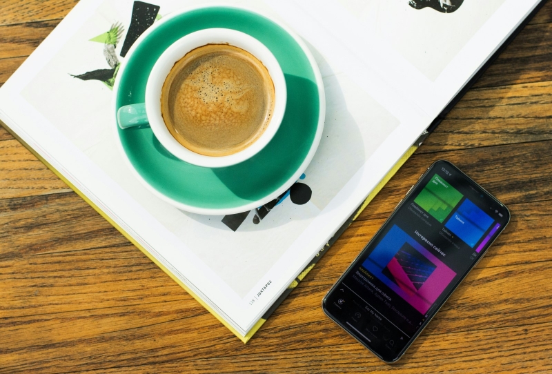Чашка кофе и телефон с Яндекс.Музыкой